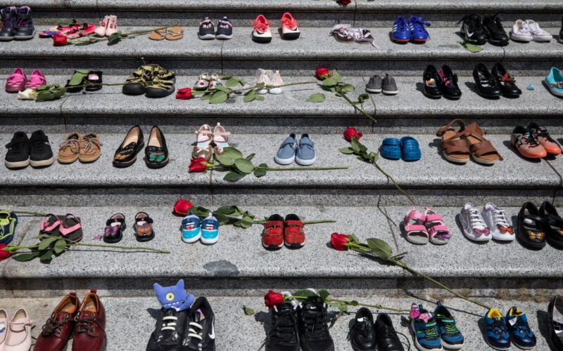 Image of children's shoes placed on the steps of the Vancouver Art Gallery as a memorial to the 215 children whose remains were found at a residential school in Kamloops.