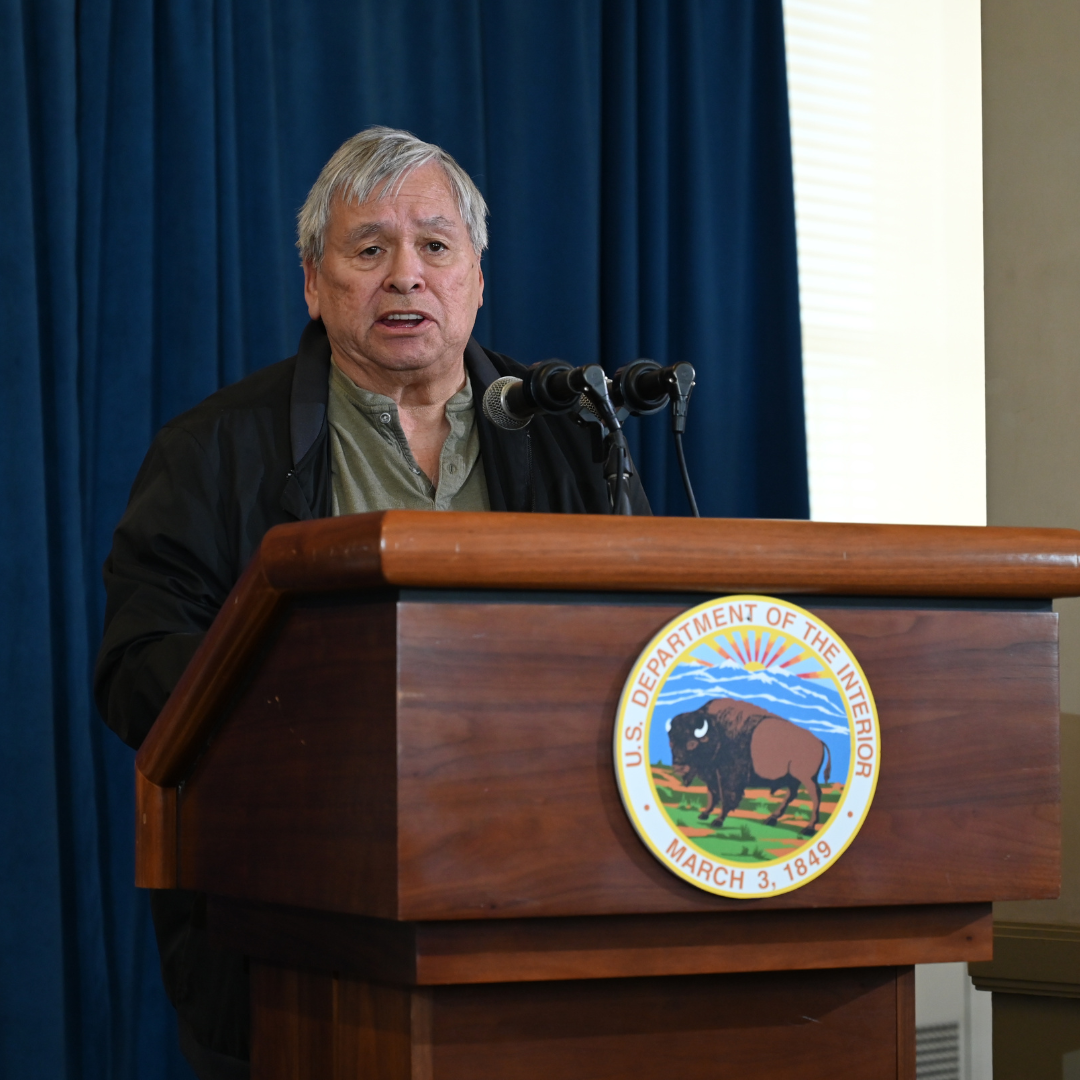 NABS Board Member Jim LaBelle Sr. speaks behind a DOI podium at the 2022 Federal Indian boarding school investigative report press conference.