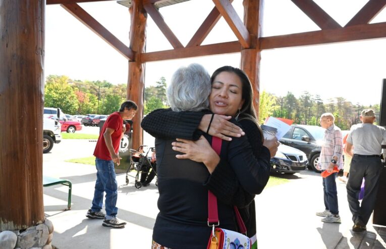 Director of Indigenous Mindfulness, Serene Thin Elk hugs an elder after ceremony in Michigan.
