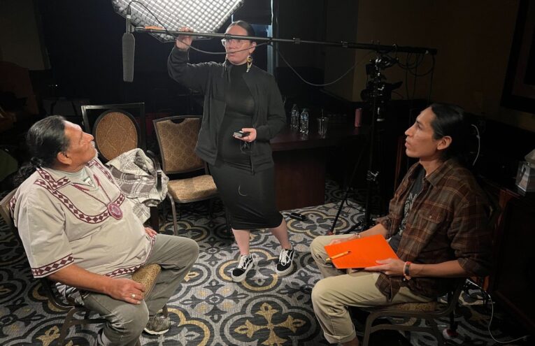 A survivor sits for an interview with Oral Historian, Markie Bear Eagle, in Oklahoma.
